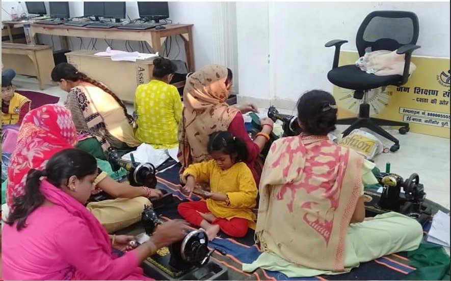 Women learning tailoring in ZSF stitching center
